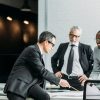 multiethnic-businessmen-discussing-new-business-strategy-on-meeting-in-office